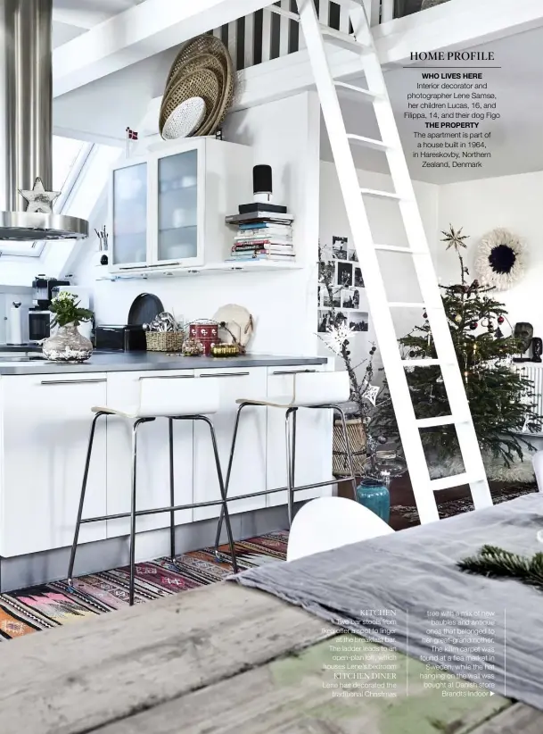  ??  ?? KITCHEN Two bar stools from Ikea offer a spot to linger at the breakfast bar. The ladder leads to an open-plan loft, which houses Lene’s bedroom
KITCHEN DINER Lene has decorated the traditiona­l Christmas HOME PROFILE WHO LIVES HERE Interior decorator and photograph­er Lene Samsø, her children Lucas, 16, and Filippa, 14, and their dog Figo THE PROPERTY The apartment is part of a house built in 1964, in Hareskovby, Northern Zealand, Denmark tree with a mix of new baubles and antique ones that belonged to her great-grandmothe­r. The kilim carpet was found at a flea market in Sweden, while the hat hanging on the wall was bought at Danish store Brandts Indoor