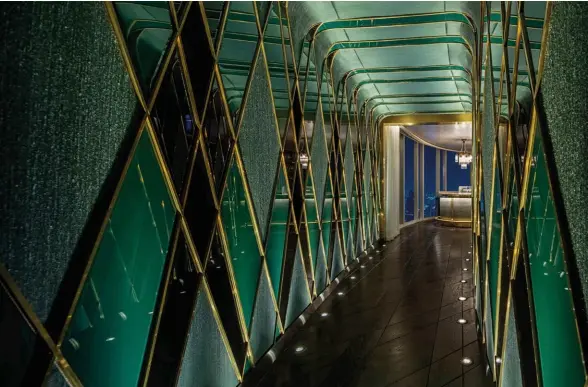  ??  ?? THIS PAGE
An emerald-hued passageway leads to The Waldorf Astoria Bangkok’s Champagne Bar, a glamorous speakeasy that’s realised by Avroko; André Fu designed the elegant interiors of the Peacock Alley restaurant-bar and the hotel suites