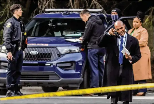  ?? JOHN SPINK/AJC 2022 ?? Homicide Commander Lt. Ralph Woolfolk works a crime scene in February. “Your heart drops every time we’re called out to these scenes,” Woolfolk said. “That feeling never goes away. These families are hurt, and they have to adjust their entire way of life as a result of this violence.”