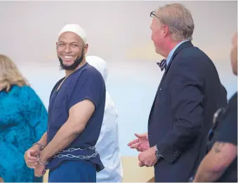  ?? ROBERTO E. ROSALES/JOURNAL ?? Siraj Ibn Wahhaj jokes with his defense attorney, Tom Clark of Santa Fe, after a judge ruled that he and four other defendants from a Taos County compound raided Aug. 3 can be released from jail after a Monday hearing.