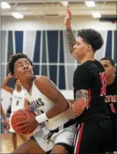  ?? RANDY MEYERS — THE MORNING JOURNAL ?? Lorain’s Jordan Jackson looks to shoot over Josh Ball of Elyria along the baseline.