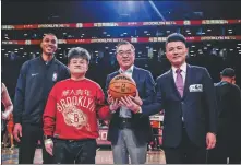  ?? THE BROOKLYN NETS ?? China’s Consul General in New York Huang Ping (second from right), founder of Wah Yan Ching Nin Wang Peng (third from right) and CEO of Venturant Group Liao Yu (right) tip off the ball for the Brooklyn Nets’ Chinese New Year game at Barclays Center on Feb 13.