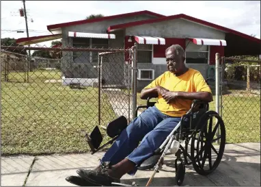  ?? (TNS/South Florida Sun Sentinel/ Carline Jean) ?? Robert Felder, 91, sits in front of his Fort Lauderdale home where police are investigat­ing his claim that someone filed a fraudulent deed transfer and forged his signature in an effort to steal and sell the home he’s lived in for 61 years.