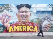  ??  ?? A pedestrian walks past a mural depicting North Korean leader Kim Jong-un in Los Angeles, California on Monday.