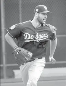  ?? Morry Gash Associated Press ?? CLAYTON KERSHAW, doing a drill in spring training, is working his way back from shoulder inf lammation.