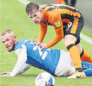  ??  ?? EYES ON THE BALL Hull’s Keane Lewis-Potter vies for possession with Joe Ward