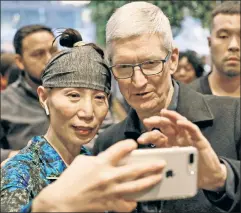  ??  ?? In your hands: Apple CEO Tim Cook and an iPhone user take a selfie.