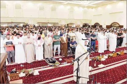  ?? Photo by Mahmoud Jadeed ?? The ‘Imam’ leads the prayer as Muslim faithful gather in a mosque in Kuwait for the late night prayer (Qiyam), in the last ten days of the holy month of Ramadan. Mosques throughout the country receive the worshipper­s in great numbers as they ask for forgivenes­s of their sins and reward from Allah.