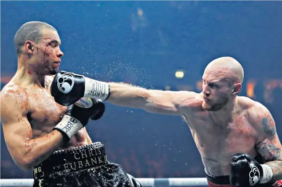  ??  ?? Punching power: George Groves catches Chris Eubank Jr with a rignt-hand blow on his way to a unanimous points victory in Manchester on Saturday night