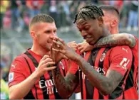  ?? ?? AC Milan’s Rafael Leao (centre) celebrates after scoring a goal during the Serie A match at Meazza stadium in Milan on Sunday. (AFP)