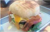  ?? MICHAEL MAYO/STAFF ?? The breakfast chappa at Revenant Coffee House features an egg, bacon, ham, cheddar cheese, avocado and arugula.