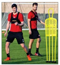  ??  ?? ADMIRATION: Arnason keeps a watchful eye on McKenna (left) during a Dons’ training session in Dubai