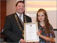  ??  ?? Cathaoirle­ach of Sligo County Council, Cllr. Martin Baker making a presentati­on to Aoife Johnston who was 1st in Duet at the All Ireland Fleadh.