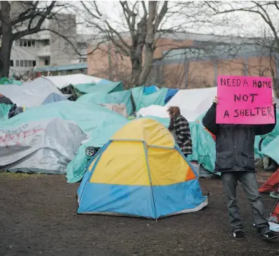  ?? CHAD HIPOLITO/ THE CANADIAN PRESS ?? Poverty is a pressing problem in Canadian cities, but government initiative­s are helping communitie­s explore solutions, argue Wayne Wouters and Deb Matthews.