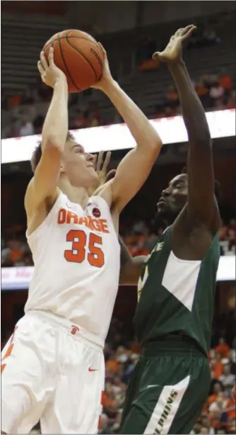  ?? NICK LISI - THE ASSOCIATED PRESS ?? Syracuse’s Buddy Boeheim, left, shoots against Le Moyne’s Souleymane Gueye during the first half of an NCAA college basketball game in Syracuse, N.Y., Wednesday, Oct. 31, 2018.