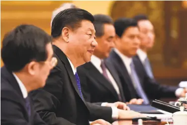  ?? Madoka Ikegami / AFP / Getty Images ?? Chinese President Xi Jinping (second from left) discusses trade during a meeting in Beijing.