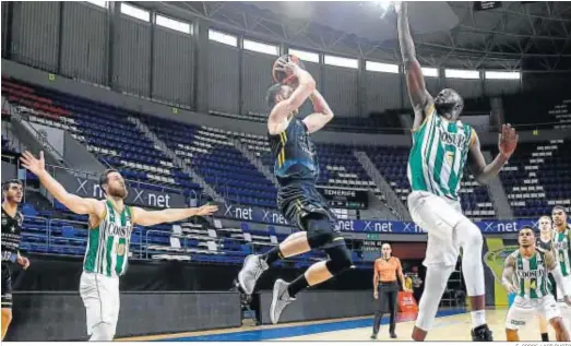  ?? E. COBOS / ACB PHOTO ?? Ndoye trata de obstaculiz­ar a Marcelinho Huertas, que busca en el aire algún compañero al que pasar la pelota ante la imposibili­dad de lanzar.