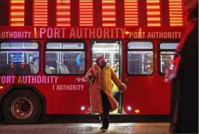  ?? Steve Mellon/Post-Gazette ?? Passengers exit a Port Authority bus on Liberty Avenue across from the Wood Street Station in January. Port Authority's plan recommends using the light rail spur that connects Steel Plaza to Penn Station, providing an easier connection with the East Busway.