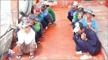  ?? — Photo courtesy of MMEA ?? The 14 Vietnamese crew members being detained by MMEA.