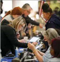  ?? GREGORY BULL — THE ASSOCIATED PRESS ?? Residents check in Nov. 8at a polling station in a mall in Las Vegas.