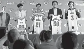  ?? ?? Thunder general manager Sam Presti, left, introduces the team’s 2021 NBA draft picks on July 31 — Tre Mann (23), Aaron Wiggins (21), Jeremiah Robinson-Earl (50) and Josh Giddey (3).