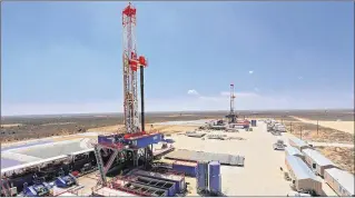  ?? CONTRIBUTE­D BY PATTERSON-UTI DRILLING CO. ?? The Patterson-UTI drilling rigs in West Texas use hydraulic feet to “walk” from one drill site to another. They are examples of the growing use of automation in drilling.