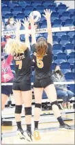  ?? Westside Eagle Observer/MIKE ECKELS ?? Lady Lions Nicole Vogt (7) and Lauren Irwin (5) try to intercept a hit from Lady Saint Lauren Glenn and deflect it back into the Lady Saints’ side of the court Sept. 3 during the Shiloh Christian-Gravette varsity volleyball match in Springdale.