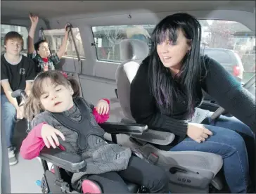  ?? Ted Rhodes/calgary Herald ?? Sarah Wilkinson has regained her family’s mobility thanks to the donation of a wheelchair-accessible van that allows her to transport her disabled daughter, Mia. In the back are Mia’s brothers, Jacob, left, 13, and Liam, 9.