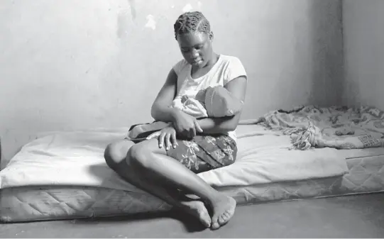  ?? TSVANGIRAY­I MUKWAZHI/AP PHOTOS 2021 ?? Virginia Mavhunga, 13, dropped out of school after becoming pregnant. She holds her child in her rural home in Murehwa, Zimbabwe.