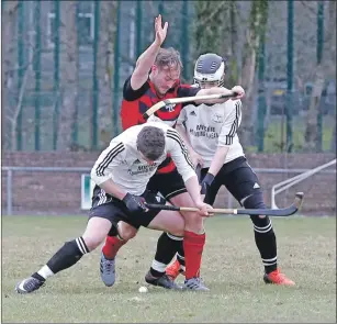  ?? Photograph: Stephen Lawson. ?? Oban Camanachd’s David Lafferty is sandwiched between Lovat players Daniel Grieve and Mark Kelly during last Saturday’s Marine Harvest Premiershi­p match at Mossfield Stadium which ended in a 2-2 draw.