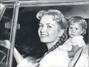  ?? Los Angeles Times ?? REYNOLDS in September 1958 with daughter Carrie Fisher, then just 23 months old, at her side.