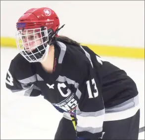  ?? Dave Stewart / Hearst Connecticu­t Media ?? Meadow Gilchrist of the Stamford/Westhill/Staples co-op girls ice hockey team awaits a faceoff during a game against New Canaan at the Darien Ice House on Saturday.