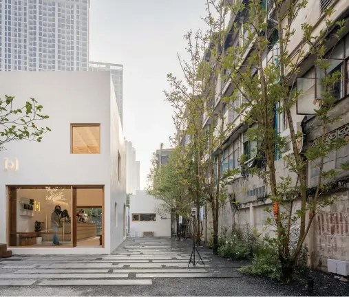  ??  ?? Architect Nantapon Junngurn’s new mixed-use space Somewhere takes over four cubic buildings in Bangkok’s Pradiphat. Two at the rear are semi-connected, and function as Junngurn’s studio and gallery, with the largest and smallest becoming coffee and
karaage spots