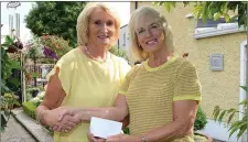  ??  ?? Ann Humphreys on the right presenting Lena Levins with a cheque for the Drogheda Hospice Homecare from a garden party recently at her home in Termonfeck­in.