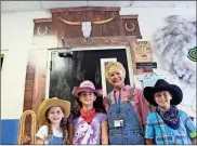  ?? / Spencer Lahr ?? Model Elementary fifth-graders Annah Mount (from left), Kendall Jones and Gavin Sapp stand outside their teacher Sue Turnquist’s Western-themed classroom on Friday, on one of their end-of-the-month PBIS dress-up days, in this case farmers.