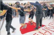  ?? AP ?? ■ Protesters walk on a Chinese national flag at a Hong Kong mall .