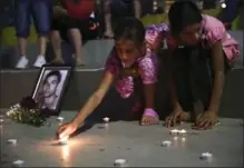  ?? VISAR KRYEZIU, THE ASSOCIATED PRESS ?? Children in Kosovo light candles in honour of those killed in Germany.