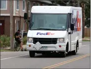  ?? (AP/David Zalubowski) ?? FedEx is preparing for the crush of holiday shipping by announcing special peak-season fees that will be in effect from Nov. 2 to Jan. 17.