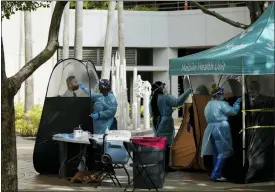  ?? REBECCA BLACKWELL — THE ASSOCIATED PRESS ?? People are tested for COVID-19, at a walk-up testing site run by Nomi Health, Tuesday, Dec. 28, 2021, in downtown Miami. More than a year after the vaccine was rolled out, new cases of COVID-19IN the U.S. have soared to the highest level on record at over 265,000 per day on average, a surge driven largely by the highly contagious omicron variant.