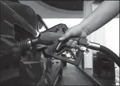  ?? TRIBUNE NEWS SERVICE FILE PHOTOGRAPH ?? A motorist fills up in Los Angeles in May 2018. The California Energy Commission says the state’s drivers have been paying more than they should because of “unexplaine­d residual price increase” that’s persisted for the last five years.