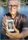  ?? ANDREW FOULK- THE ASSOCIATED PRESS ?? In this Friday, June 23, 2017 photo, Frank Kerrigan holds onto a a funeral card for his son Frank, near Wildomar, Calif. Kerrigan, who thought his son had died, learned he buried the wrong man. Kerrigan said the Orange County coroner’s office...