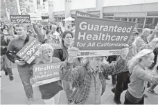  ?? RICH PEDRONCELL­I, AP ?? Supporters of single-payer health care march in Sacramento on April 26 after California’s Senate approved such a program.