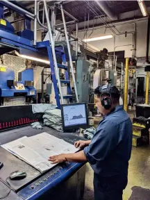  ??  ?? A press operator works at the press console inside the Times-journal pressroom. (Photo provided)