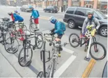  ?? Cliff Grassmick, Daily Camera file ?? Cyclists gather at The Cup food station on Pearl Street on Bike to Work Day in 2015.