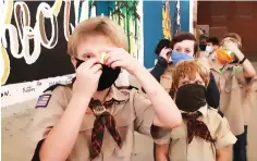  ?? Staff photo by Junius Stone ?? ■ Webelos Scout Pack 19 of Texarkana, Ark., prepares for Saturday night’s ghostly adventure in downtown Texarkana. Pack
leader James Mattson said Pack 19 is the oldest active pack in the Four States Area, establishe­d in
1949.