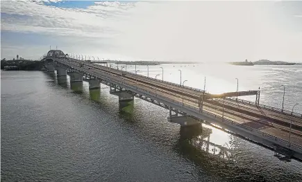  ?? JASON DORDAY/STUFF ?? An almost deserted Auckland Harbour Bridge on Tuesday. Even when we re-enter level 3, thousands of businesses are likely to remain closed.