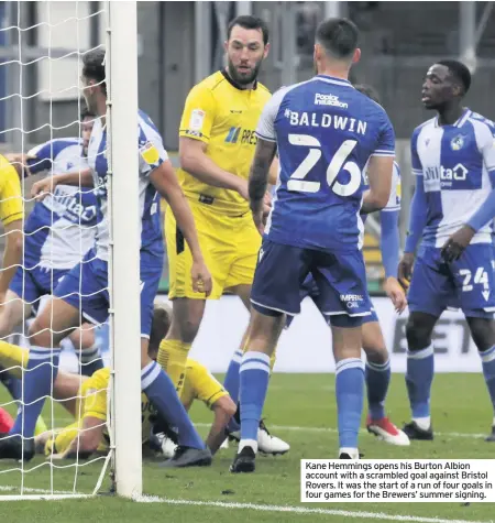  ??  ?? Kane Hemmings opens his Burton Albion account with a scrambled goal against Bristol Rovers. It was the start of a run of four goals in four games for the Brewers’ summer signing.