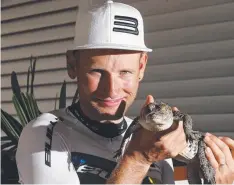  ?? Picture: STEWART McLEAN ?? ALL SMILES: 2015 Croc Trophy winner Urs Huber gets up close to a crocodile at the Wildlife Dome.