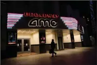  ?? The Associated Press ?? CLOSED: In this Nov. 19 file photo, a shopper walks past a closed AMC movie theater in Santa Monica, Calif. Despite the expected arrival of COVID-19 vaccines in just a few weeks, it could take several months — probably well into 2021 — before things get back to something close to normal in the U.S. and Americans can once again go to the movies, cheer at an NBA game or give Grandma a hug. AP Photo/Marcio Jose Sanchez.