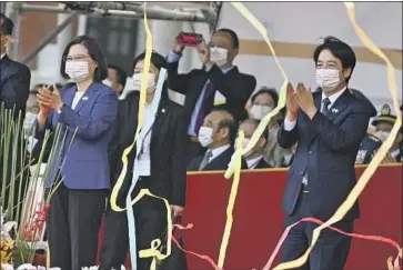  ?? Sam Yeh AFP/Getty Images ?? TAIWANESE President Tsai Ing-wen, left, and Vice President William Lai attend National Day celebratio­ns on Oct. 10. The U.S. does not contest China’s claim to Taiwan but is committed by law to the island’s defense.